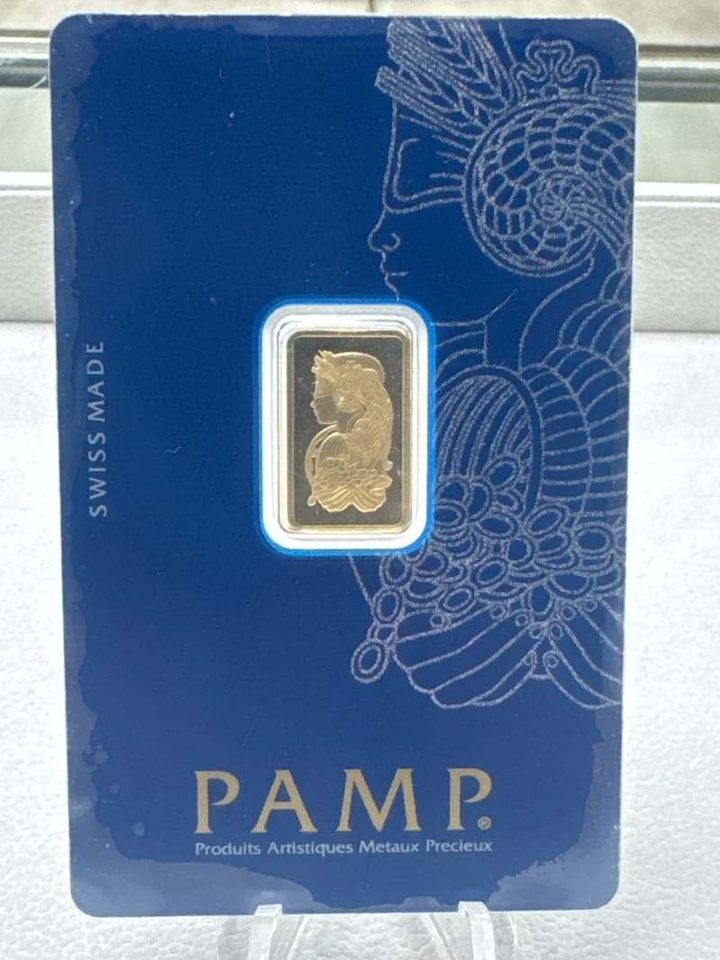 A 1 gram PAMP Suisse Lady Fortuna gold bar sealed in its blue PAMP assay card, photographed at the Bullion Reserve counter